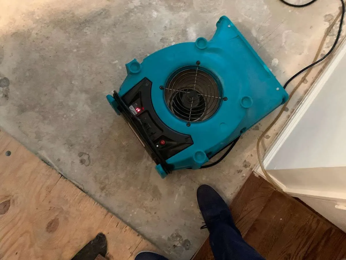 Air mover drying subfloor during Commercial Water Damage Restoration in Country Club Estates